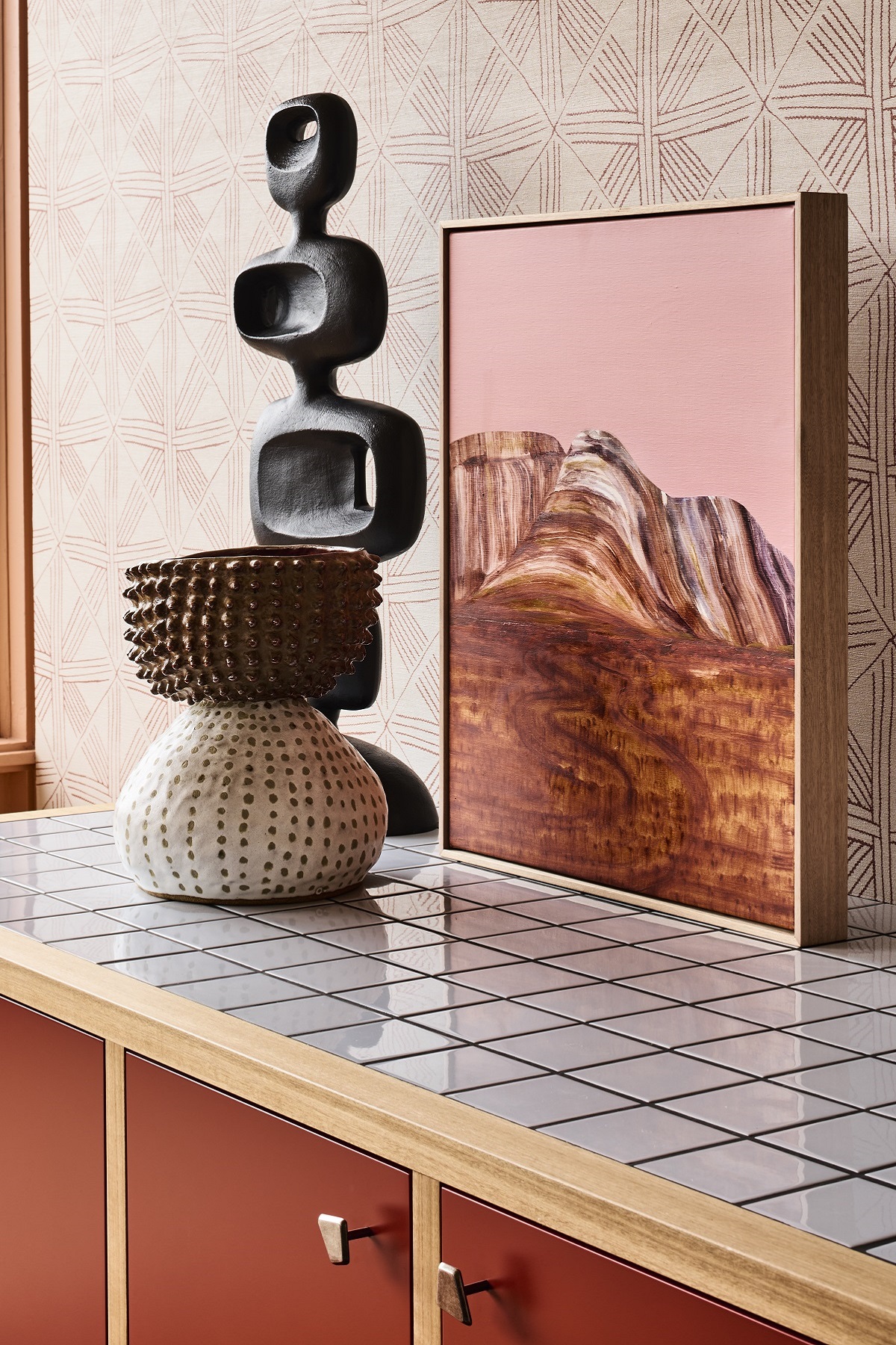 shelf detail in Flinders Motel with painting and sculpture against patterned wallpaper