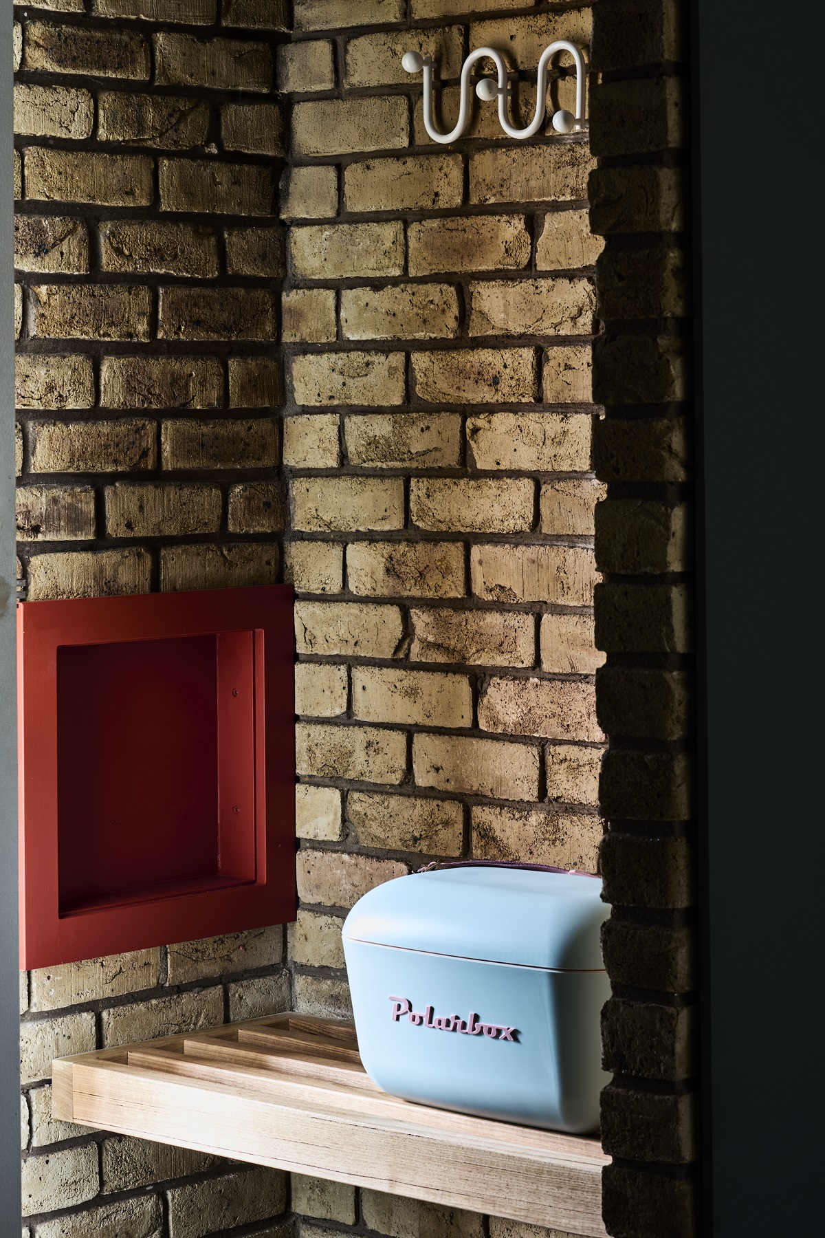 motel room detail with brick surface contrasting with blue and burnt orange details