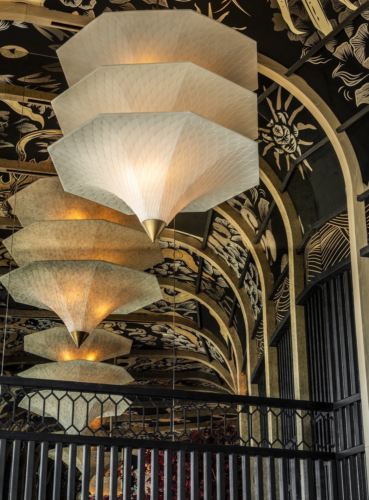 arched ceiling with balck and gold japanese mural and white lanterns