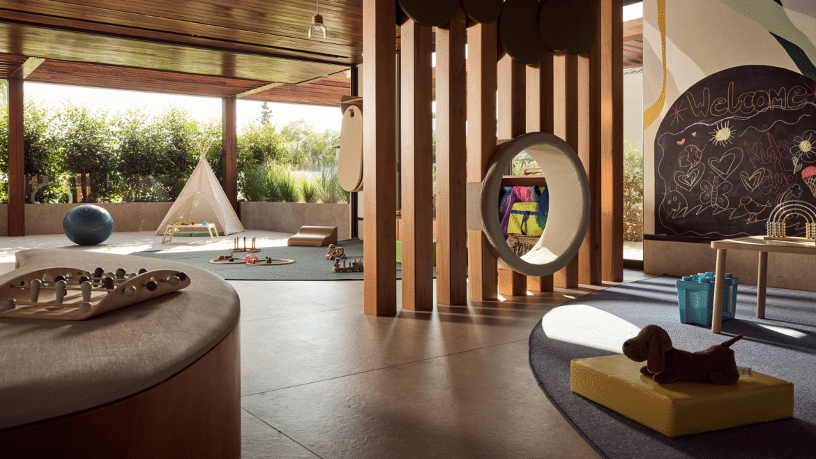 indoor childrens play area and outdoor garden with tipi in hotel design