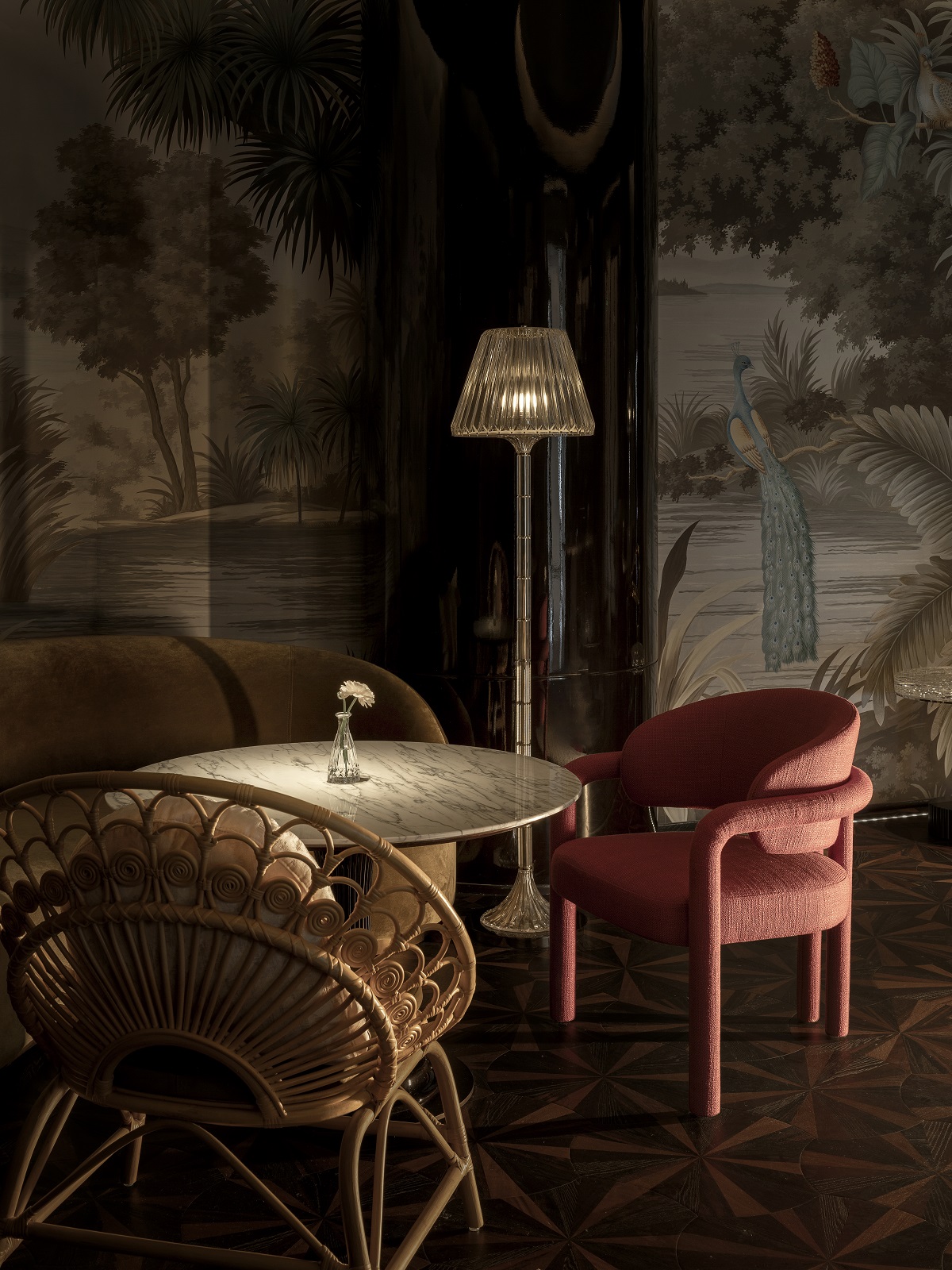 low lighting with peacock wallpaper, pink and wicker chairs