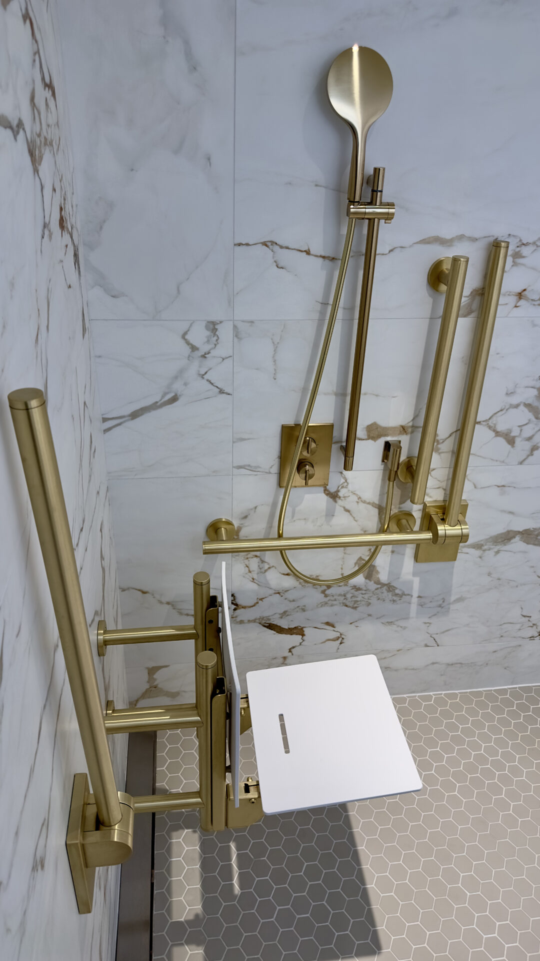 White marble and brass fixture bathroom at Montcalm Mayfair, by Fitzroy of London x Studio Mica