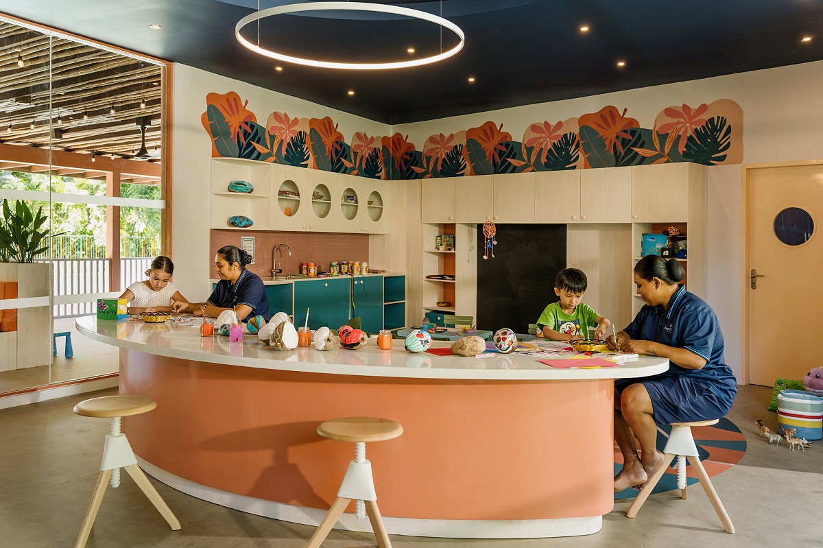 curved craft table with bar stools in hotel kids club