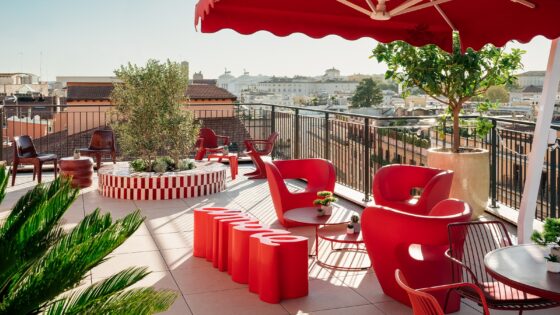 roof terrace at Ruby Giulia Rome with red parasols and chairs