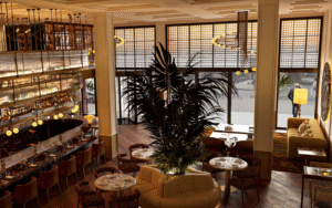 view front 2nd level looking down on bar and lobby with street views in Only YOU Hotel New York