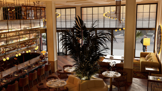 view front 2nd level looking down on bar and lobby with street views in Only YOU Hotel New York