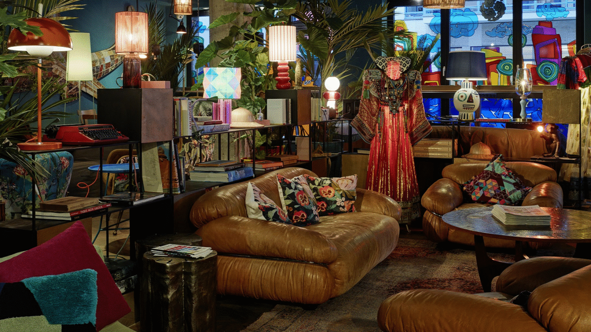 vintage lights in different shapes and colours, leather couch, plants and mannequin in 25hours Hotel The Trip redesign