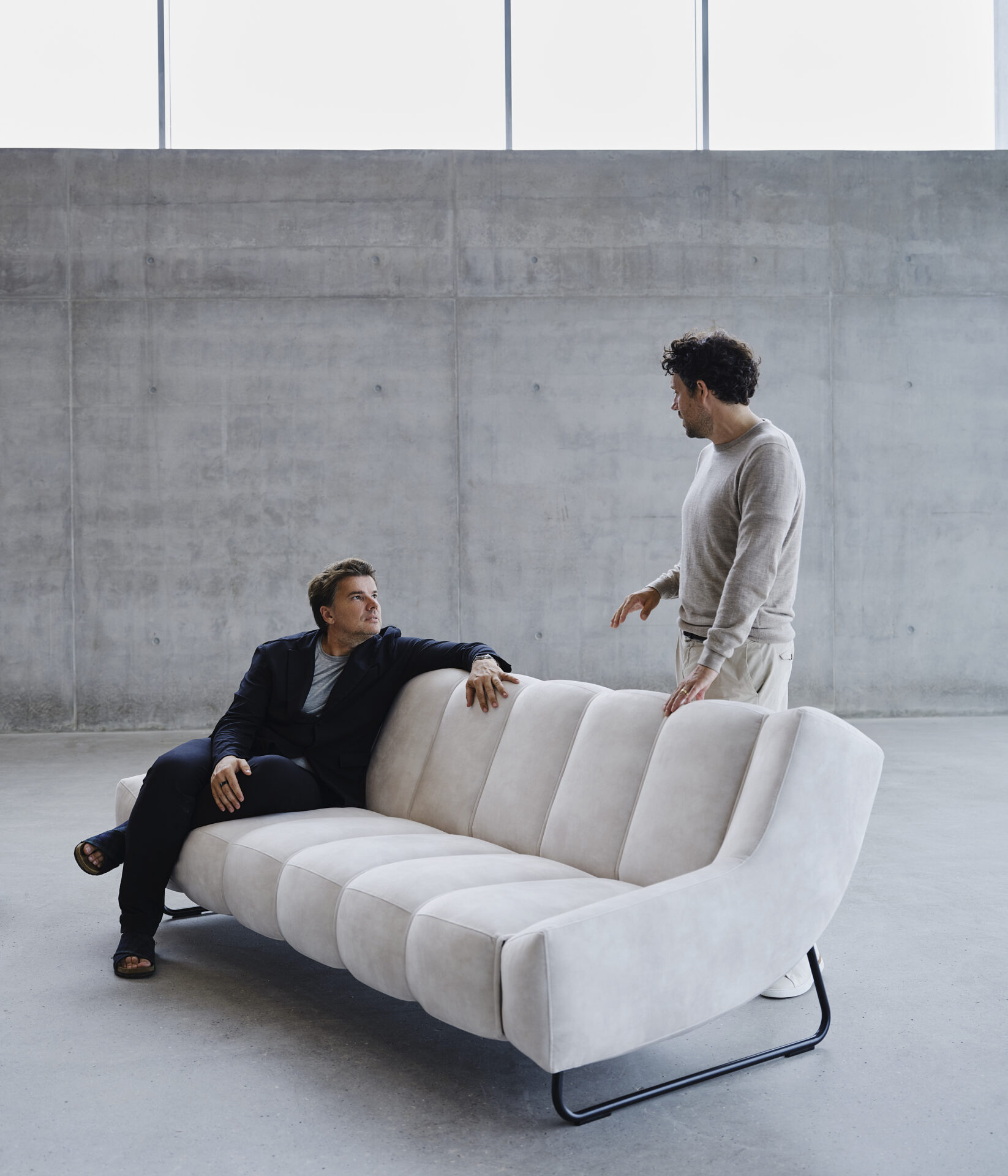 Designers Bjarke Ingels and Jakob Lange seated on BoConcept hospitality furniture Nawabari sofa