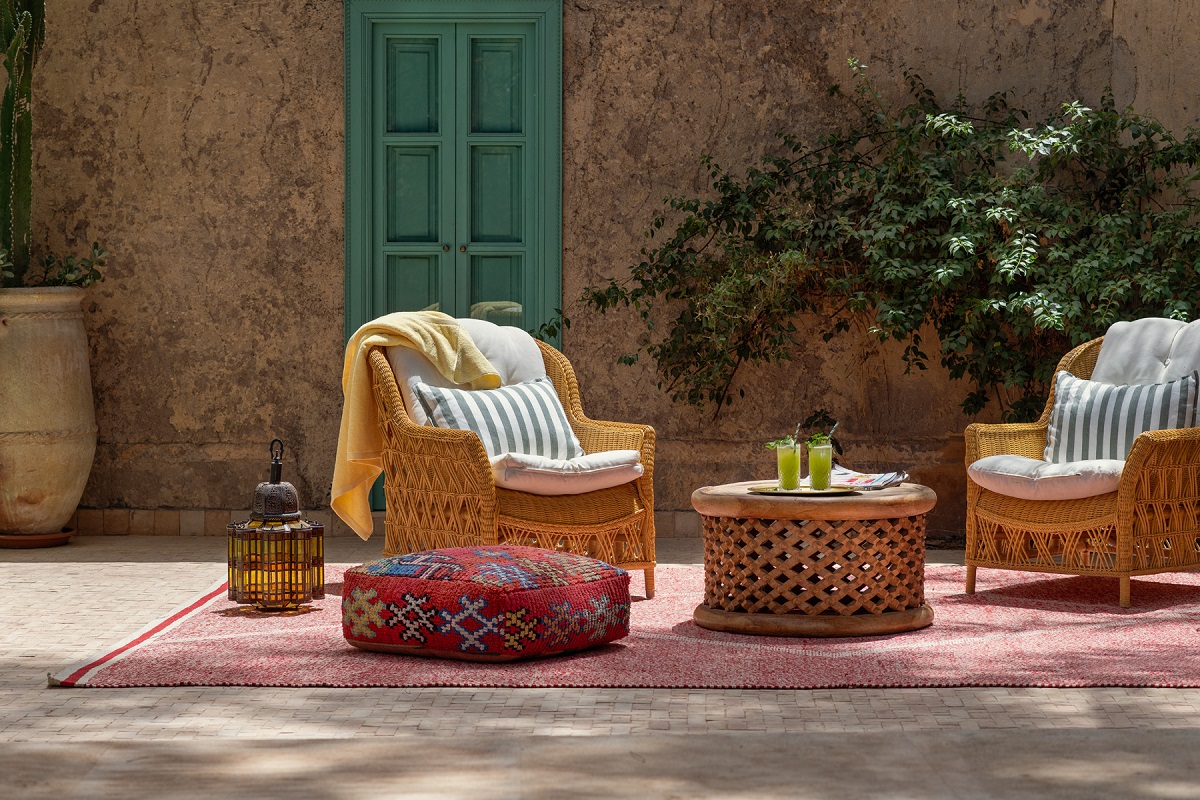 outdoor wicker chairs on a moroccan carpet at Jnane rumi
