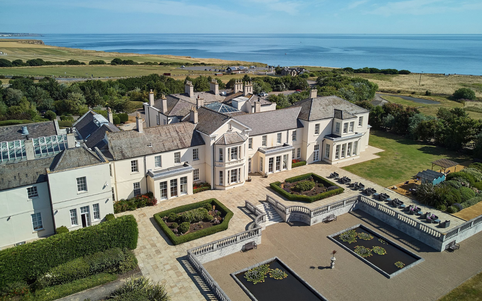 Exterior of Seaham Hall with views onto sea in background