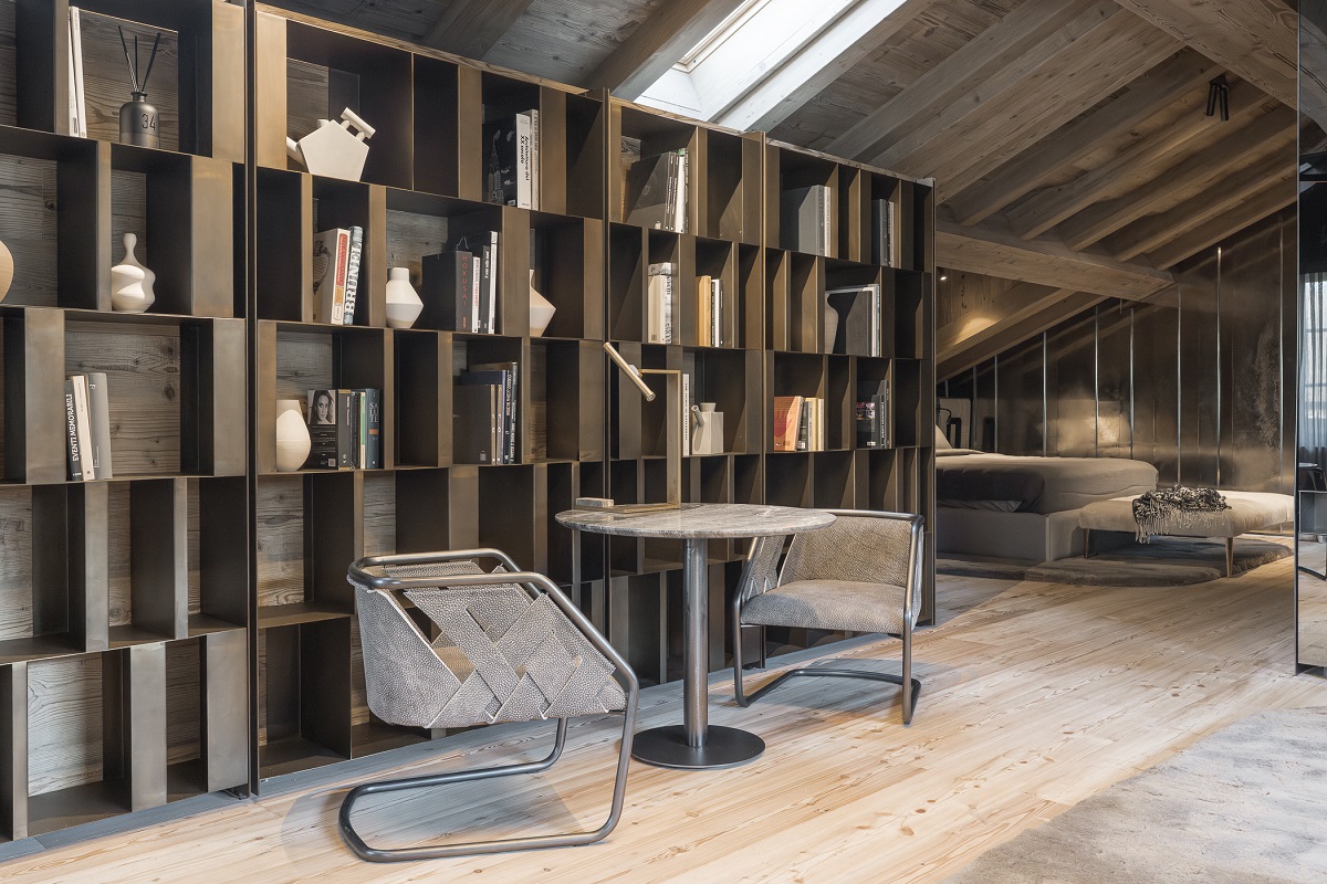 bookcase behind chair and table in contemporary chalet design suite at Rosapetra