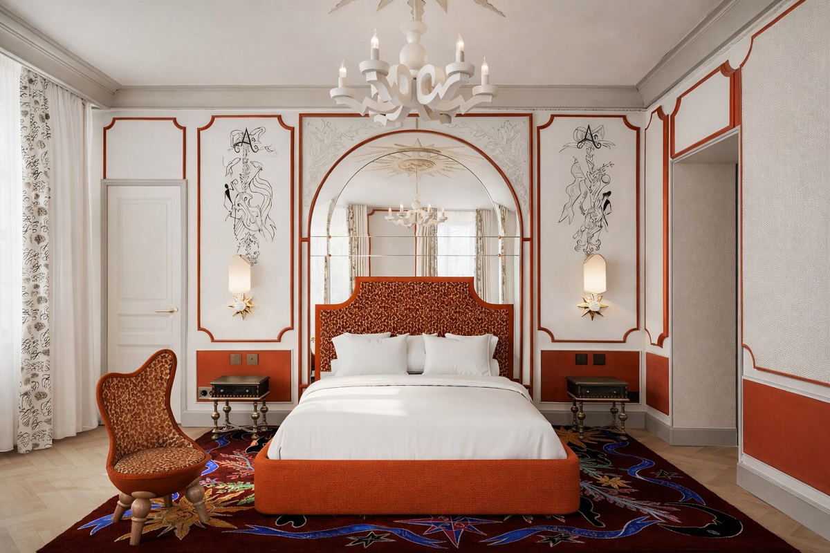 orange bed with white linen and art deco hand painted details on the wall
