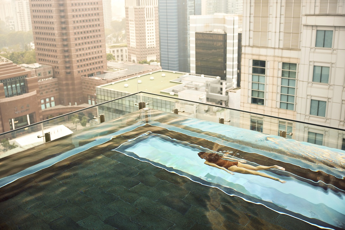 figure swimming underwater in rooftop pool singapore