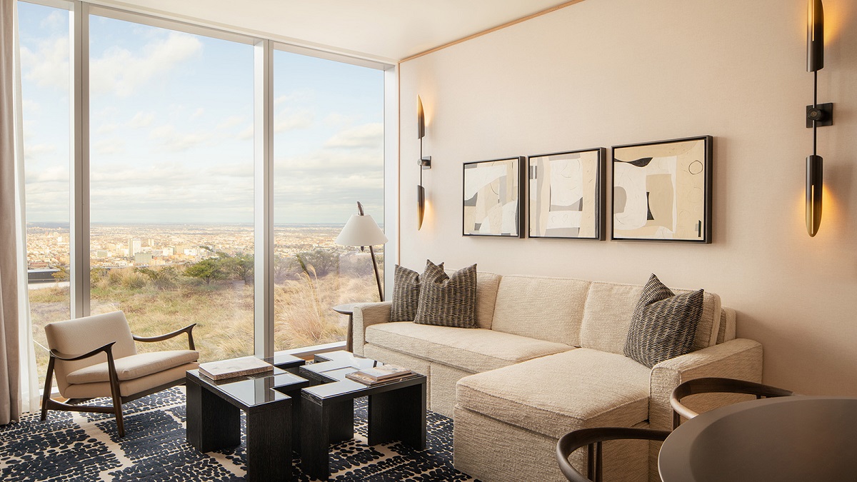  white couch and seat in Sky Garden suites with city skyline views