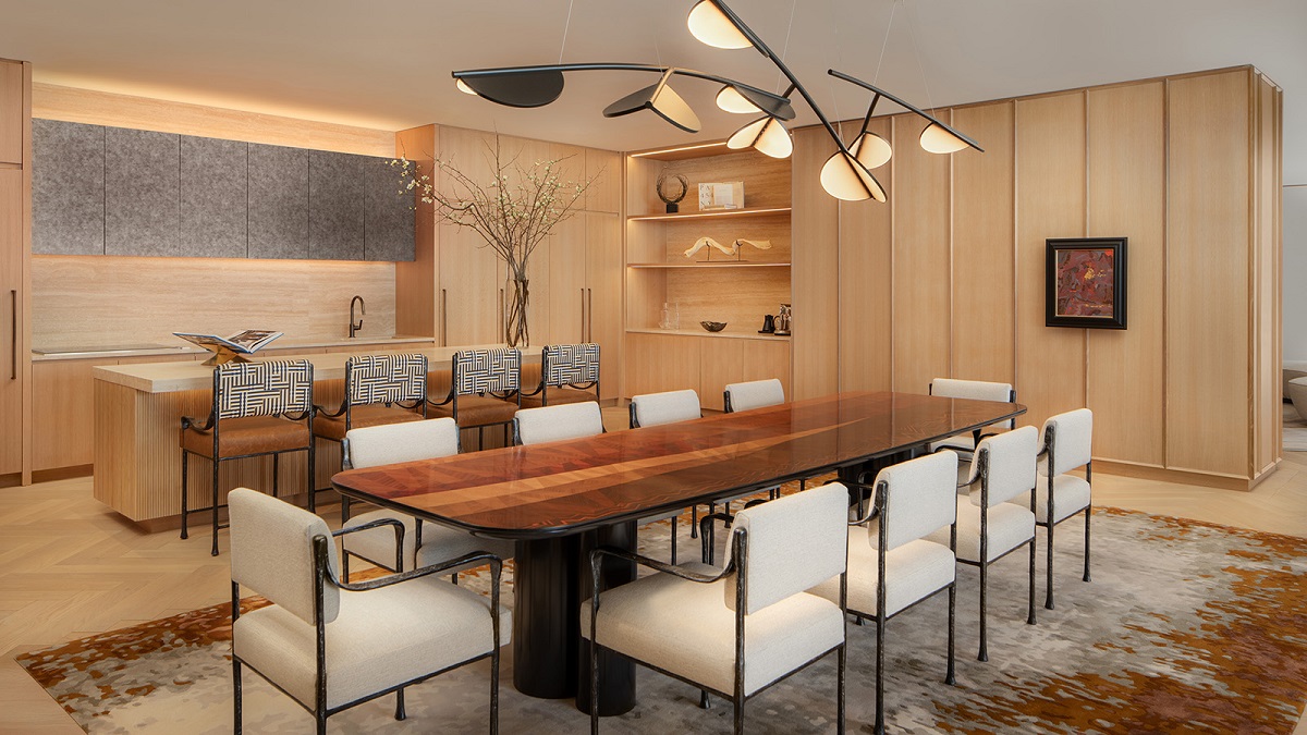wooden dining table under statement lighting feature in hotel suite