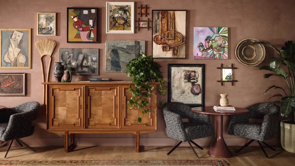 vintage cabinet and a gallery of local art in the hotel lobby of ROOST Rainey