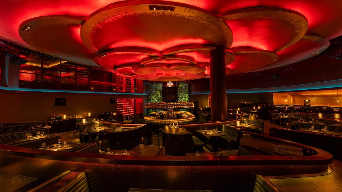 Rockwell Group design for _COTE Vegas_with red logo and ceiling lighting