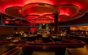 Rockwell Group design for _COTE Vegas_with red logo and ceiling lighting