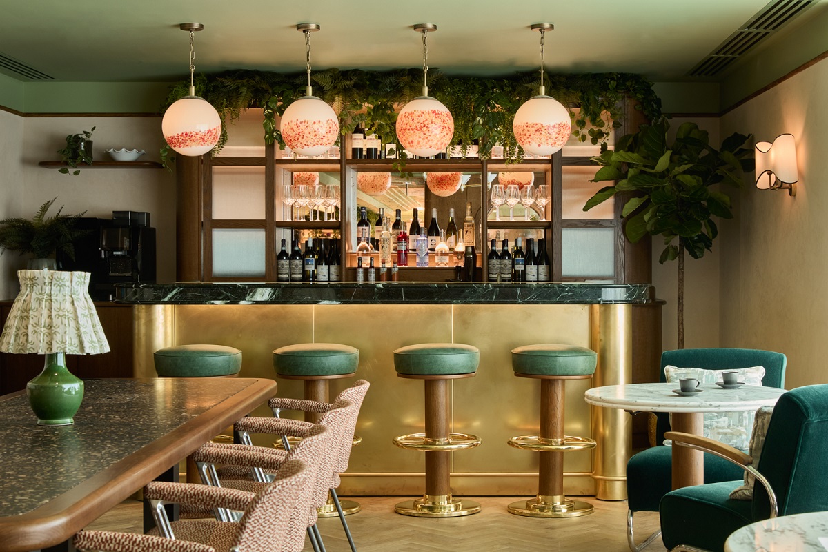 tables, chairs and downstairs bar with bespoke dome lights above the bar