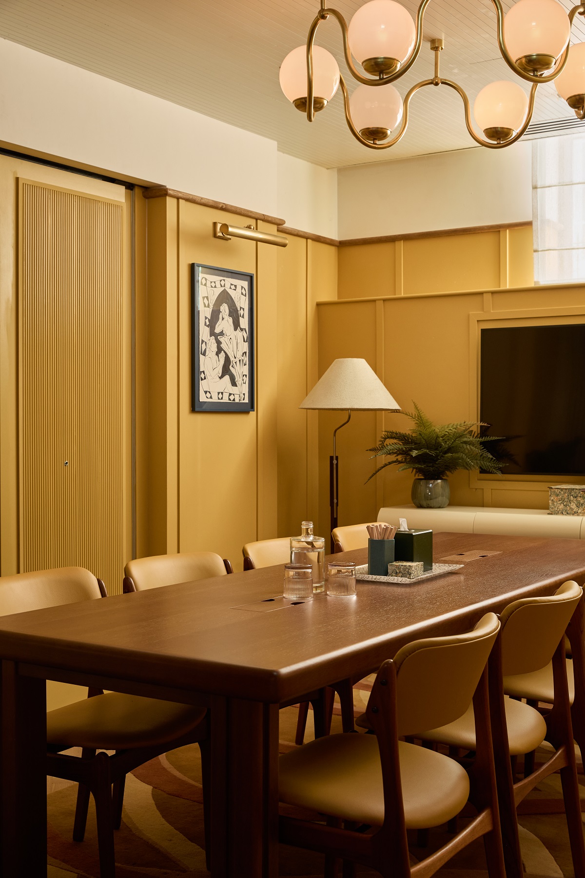 mustard yellow walls and wooden table in hotel meeting room