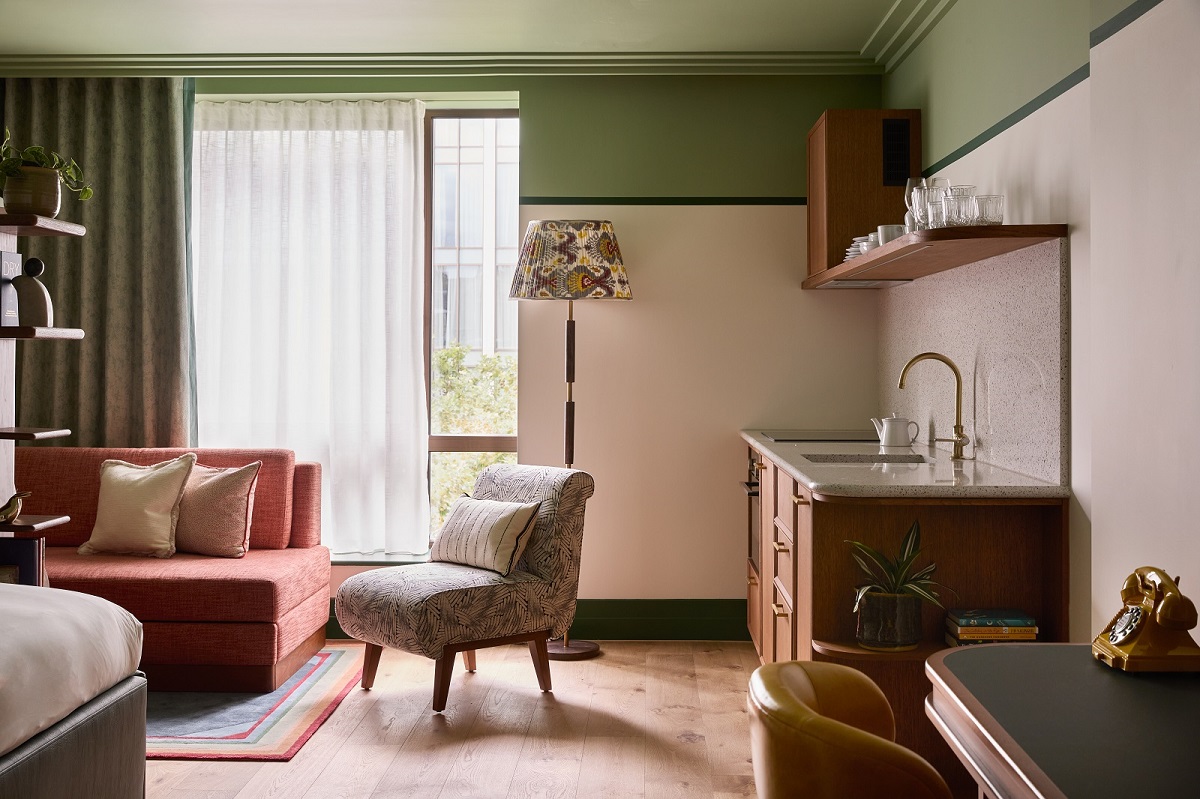 guestroom at The July victoria with galley kitchen and seating in front of window