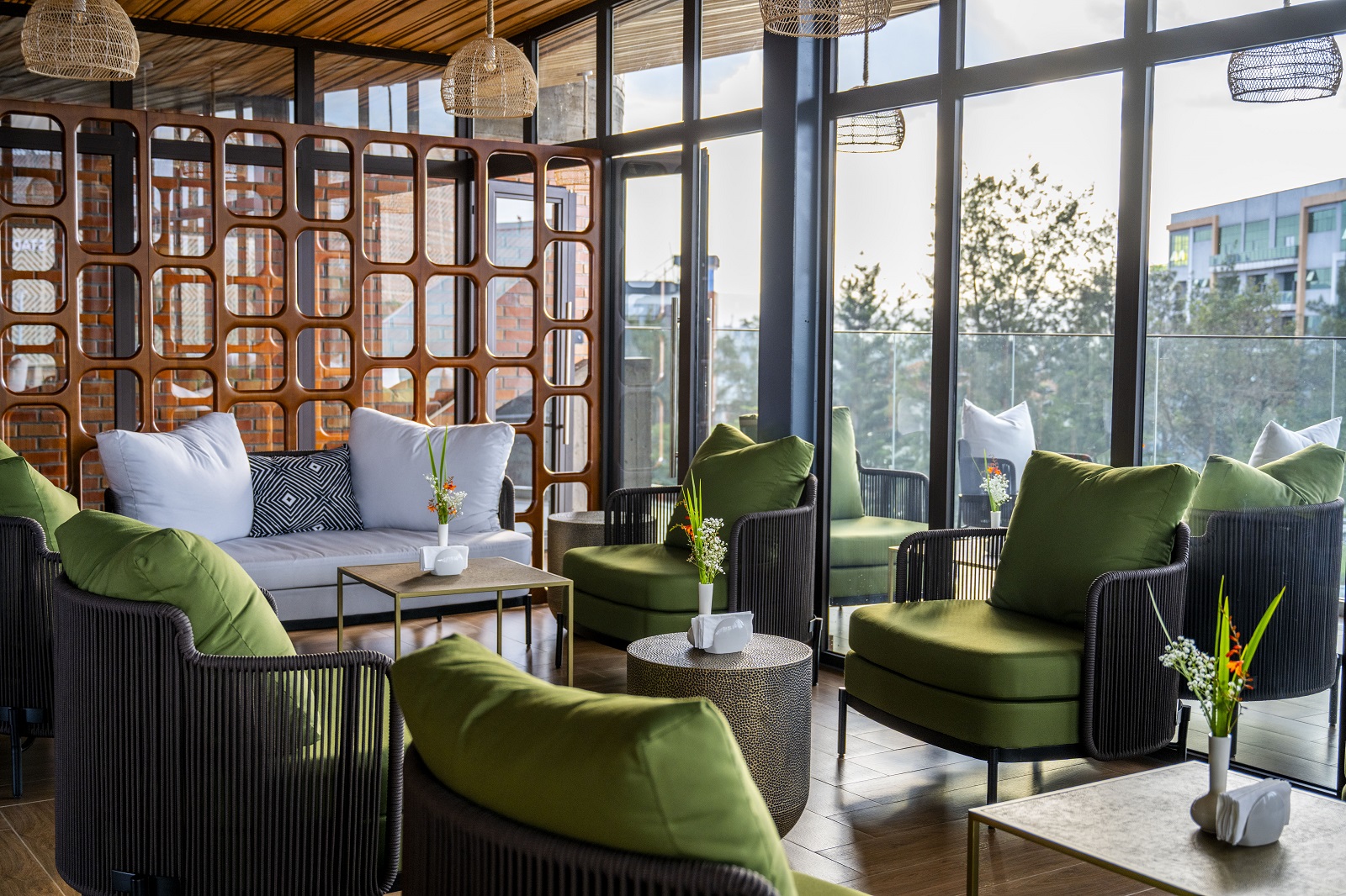 green chairs in front of floor to ceiling windows in rooftop lounge Zaria Court Kigali