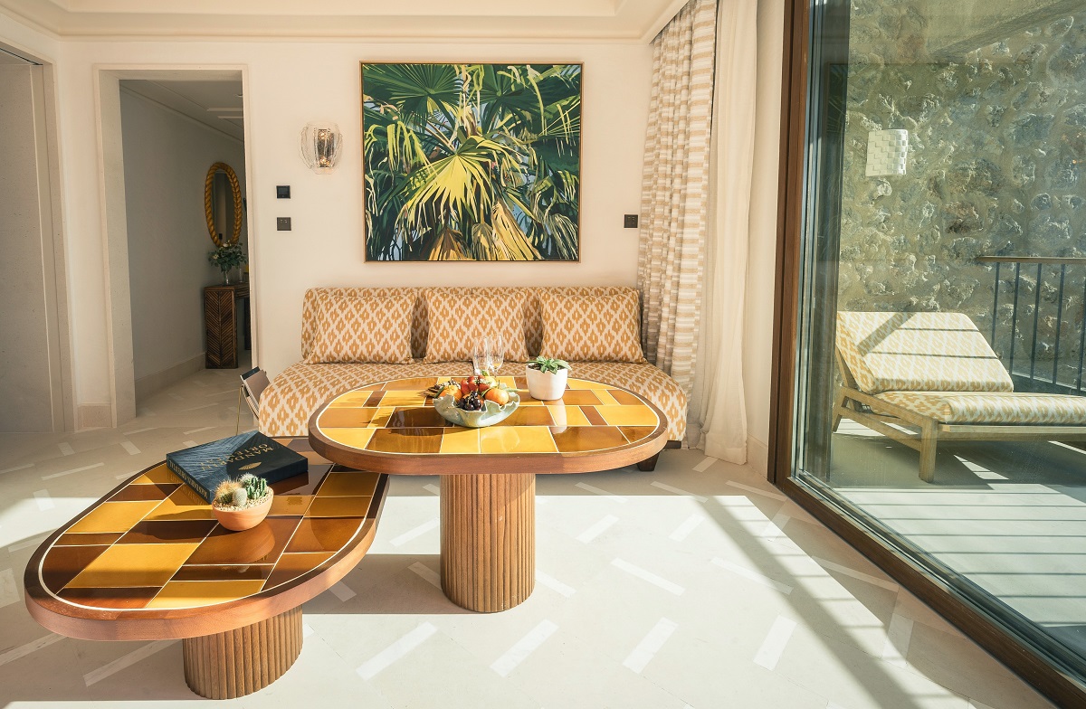 patterned yellow couch and tiled table top in hotel suite in Mallorca