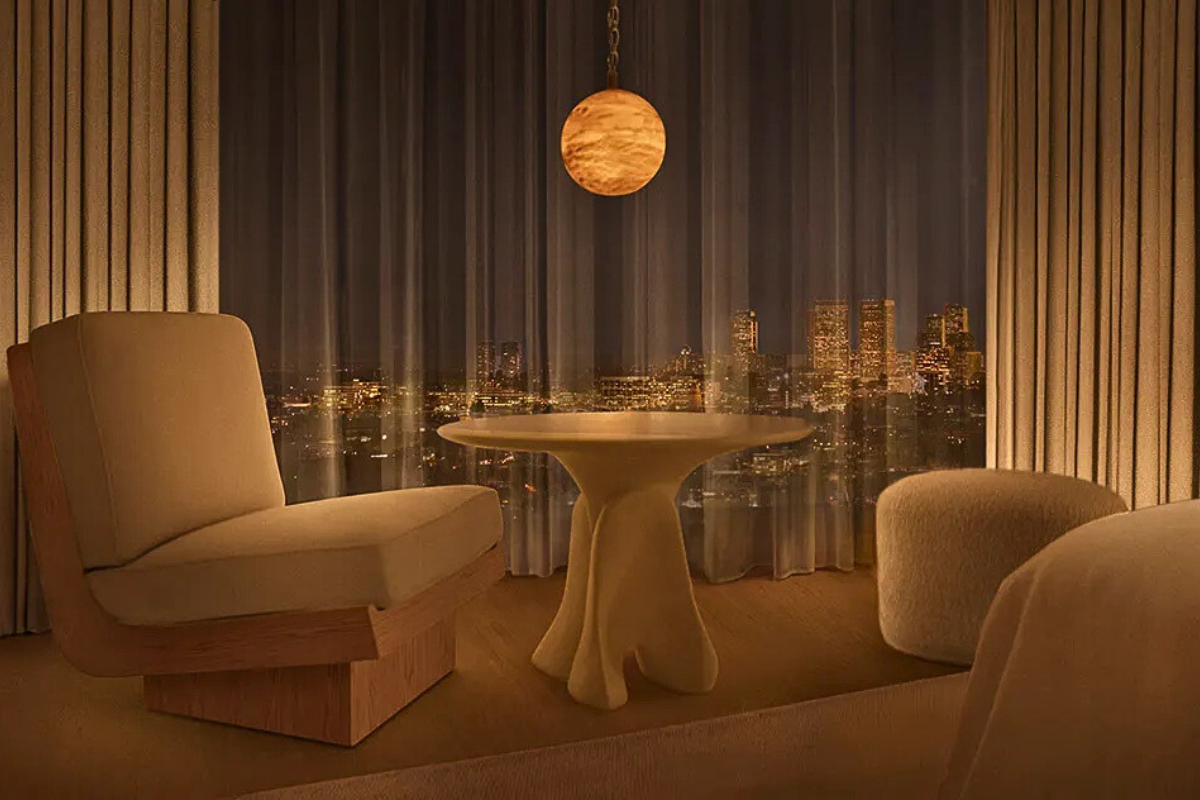 Cream boucle seating area in front of window showing Hollywood skyline at night