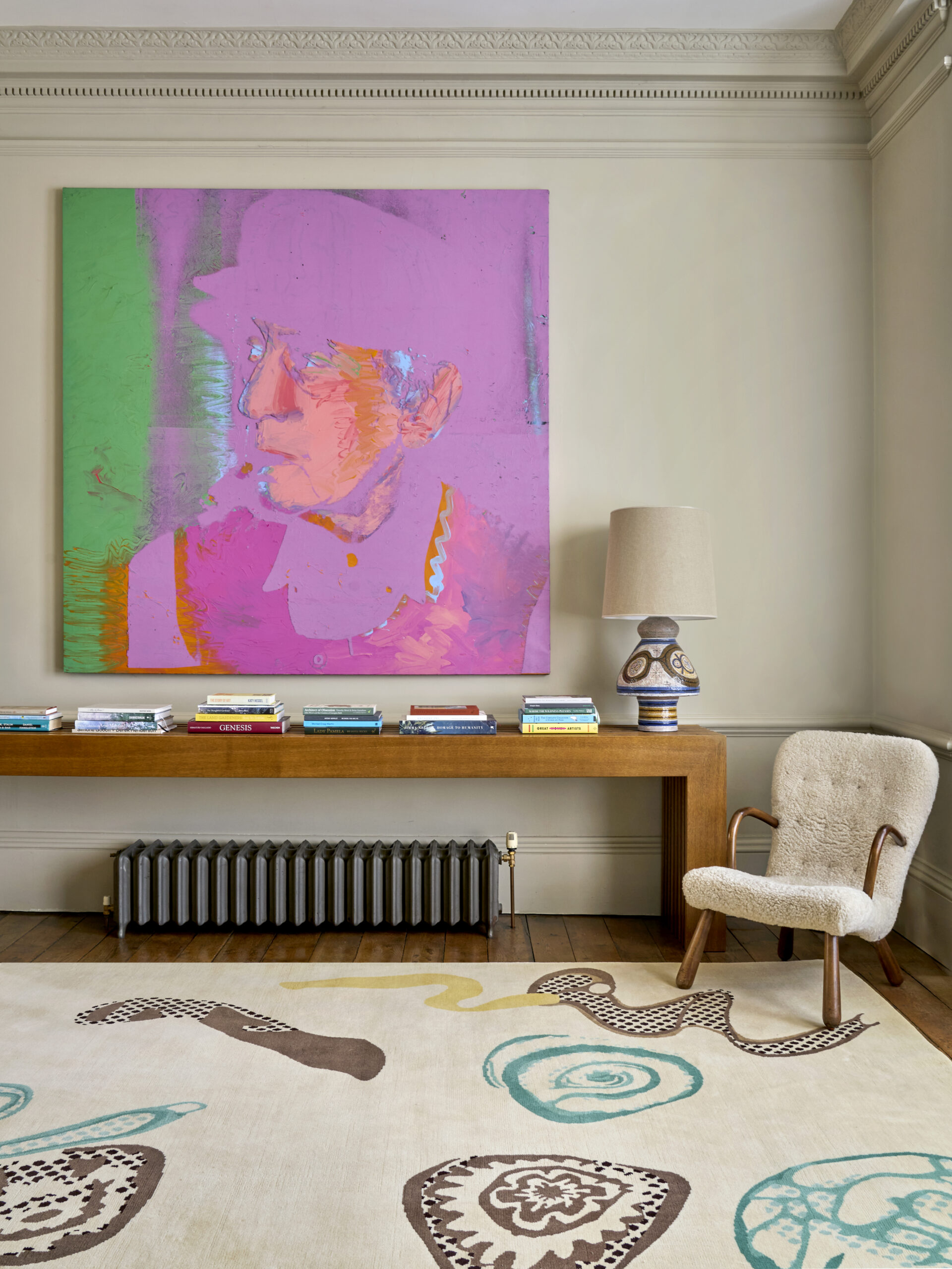 Lounge with neon art and rug by Pelican House