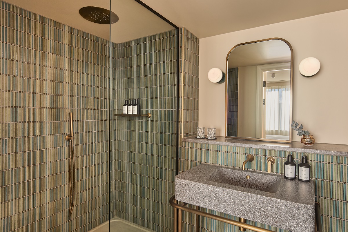 moss green tiled bathroom and shower in Hotel Indigo