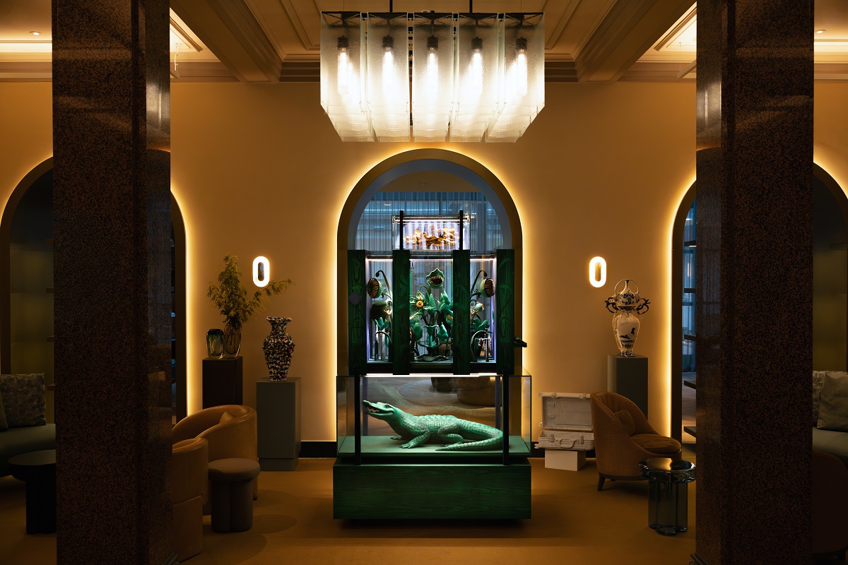 view across hotel lobby to cabinet with alligator sculpture and jewellery installation