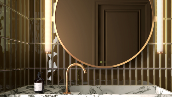Round mirror by Luma Mirros on green tiled bathroom wall