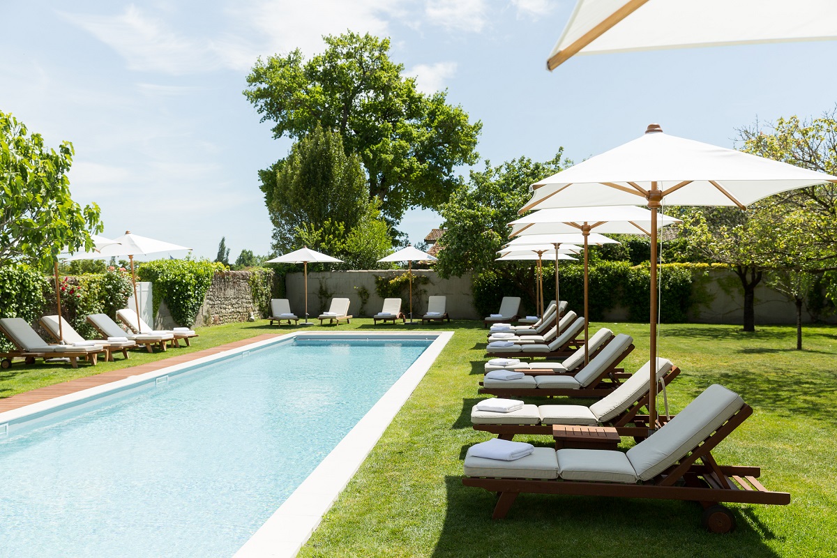 sunlounger and swiiming pool at COMO Cordeillan-Bages