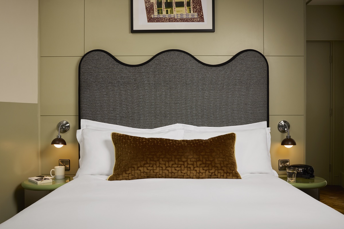 bed with curved headboard in The hoxton Shoreditch
