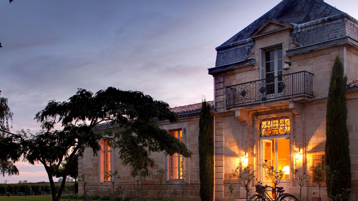 entrance to COMO Cordeillan-Bages lit up at night