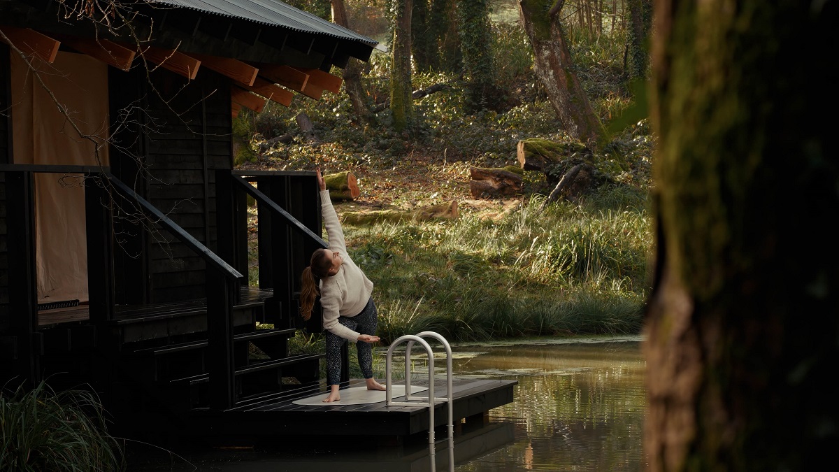 yoga on cabin platform on banks of lake