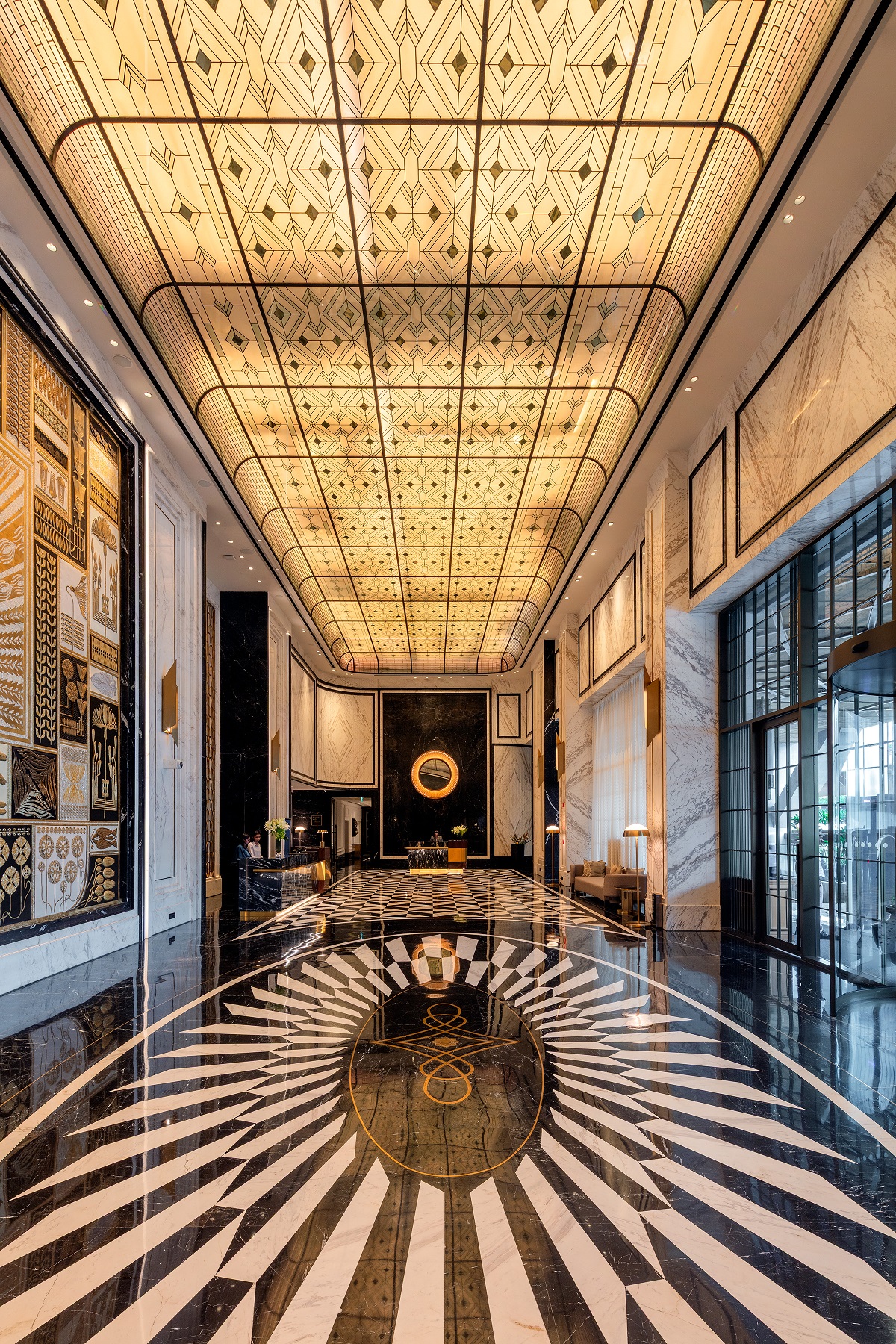 black and white striped floor pattern under glass ceiling in hotel foyer