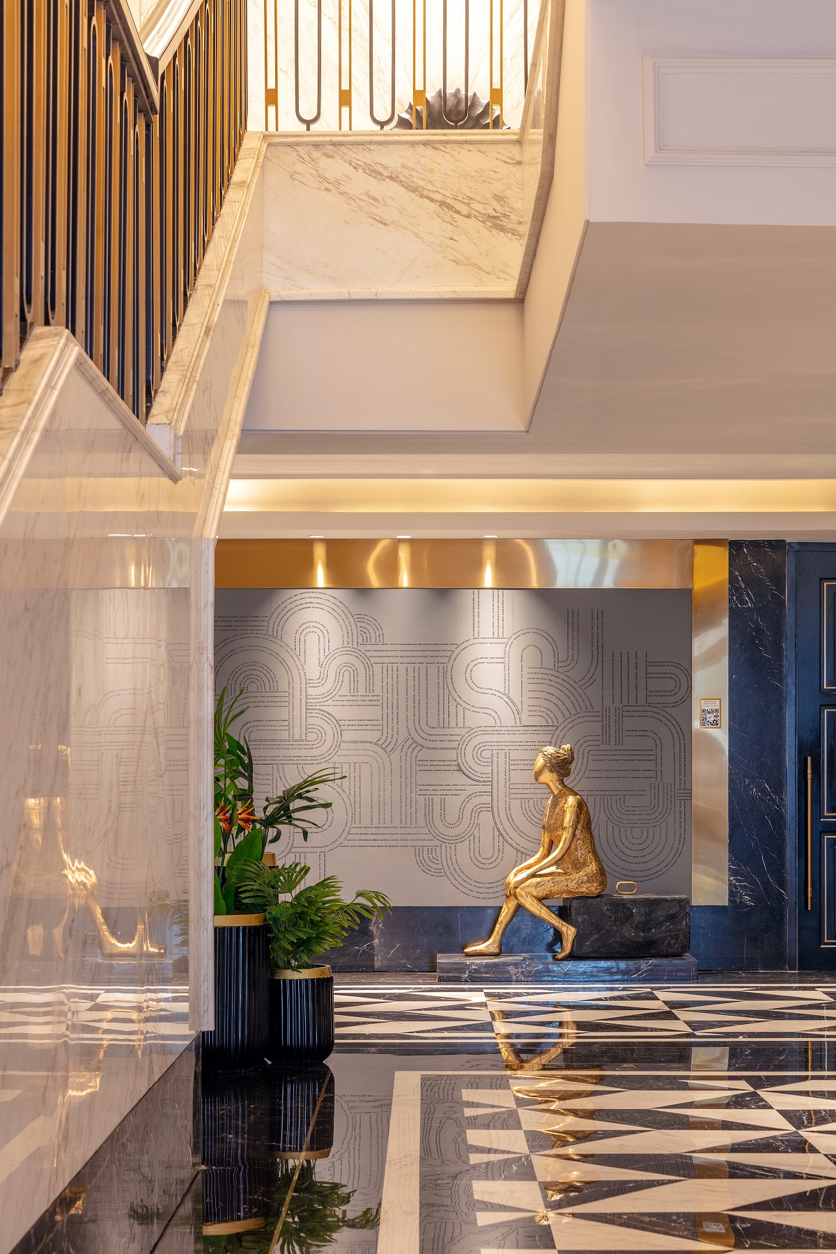 view through hotel corridor to sculpture of seated girl