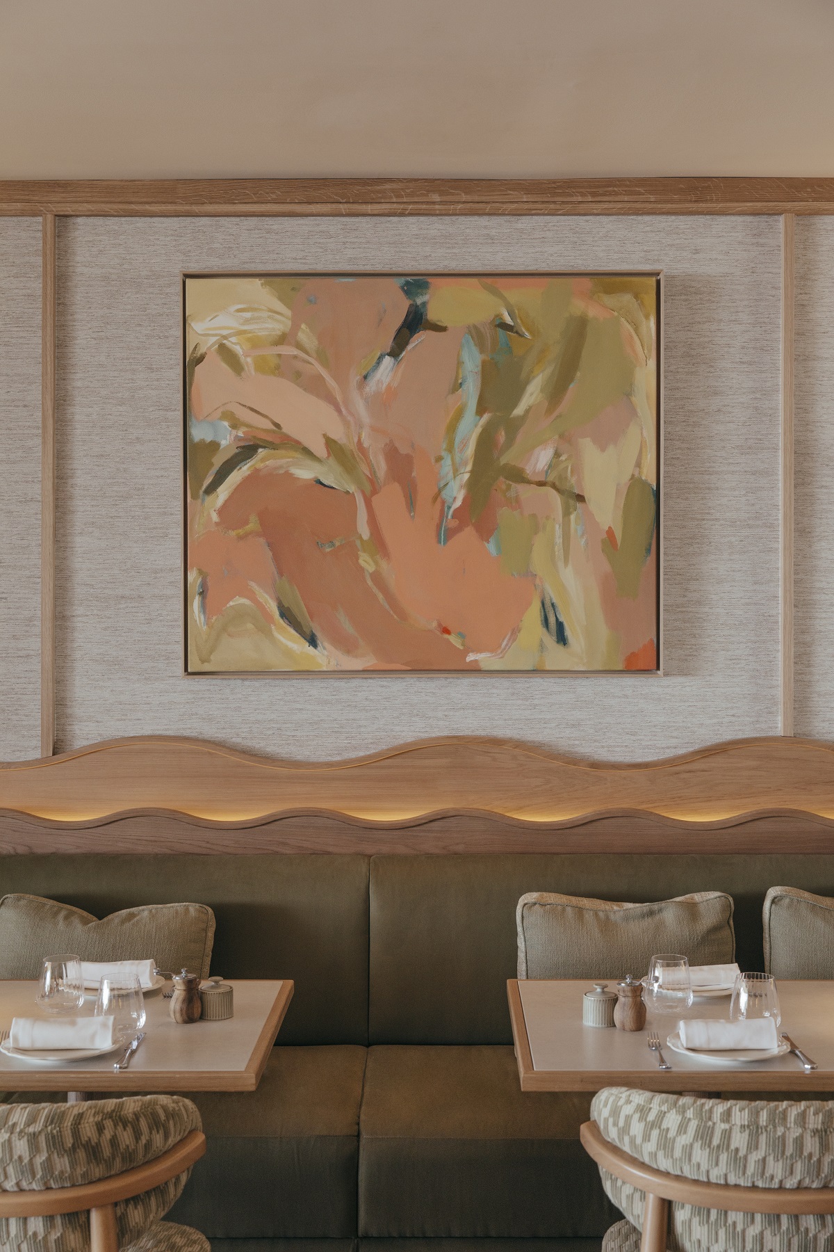 abstract painting behind curved banquette in Abarada restaurant design by Astet studio