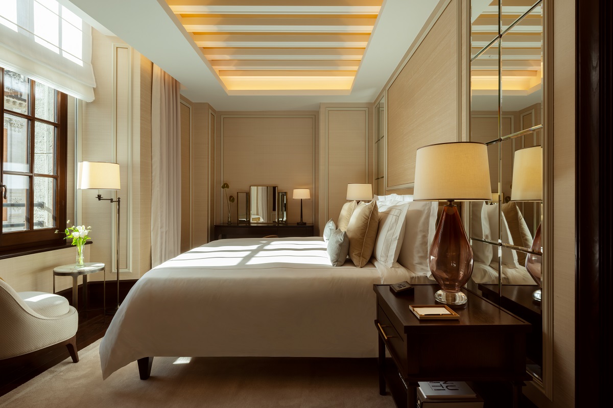 double bed with mirror behind and window in front in corinthia rome