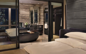 Bedroom at the Equinox Hotel New York looking into the luxury hotel bathroom