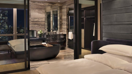 Bedroom at the Equinox Hotel New York looking into the luxury hotel bathroom