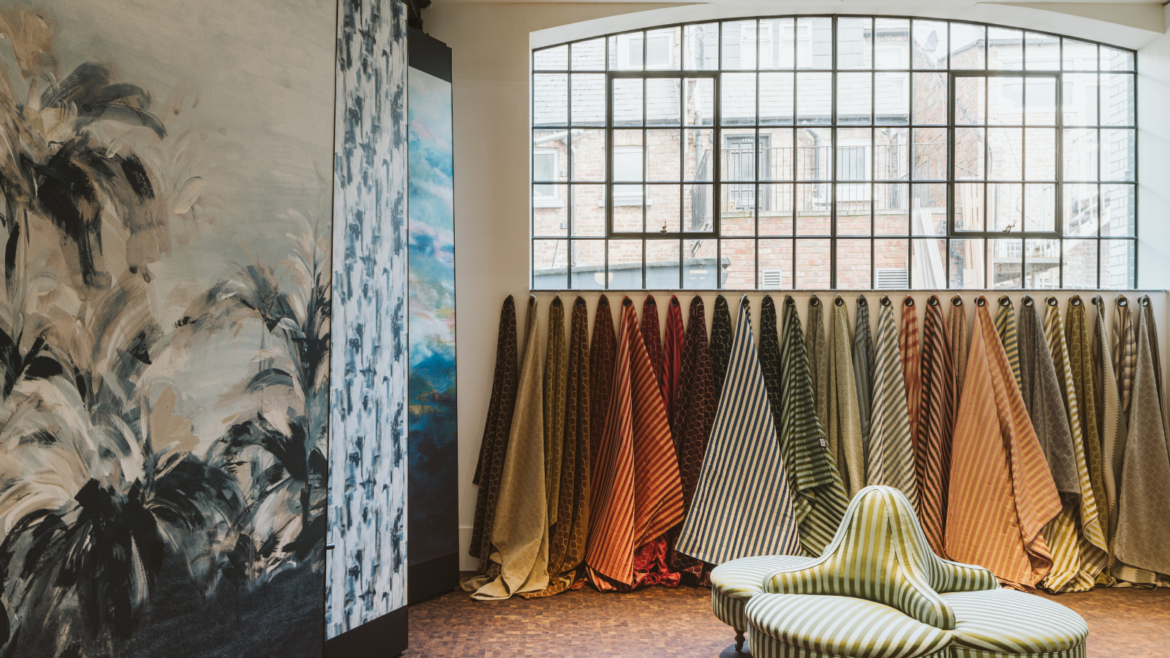 Interior of Voysey House, with Crital window above a line of fabric swatches hanging from the wall