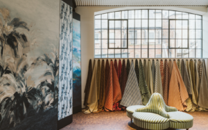 Interior of Voysey House, with Crital window above a line of fabric swatches hanging from the wall
