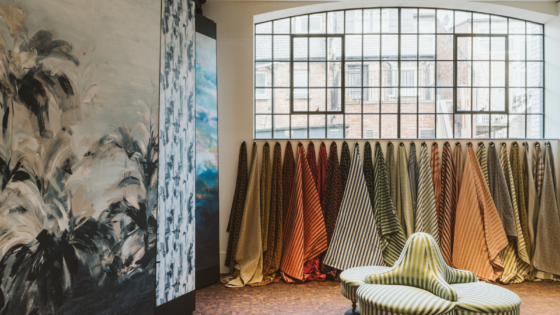 Interior of Voysey House, with Crital window above a line of fabric swatches hanging from the wall