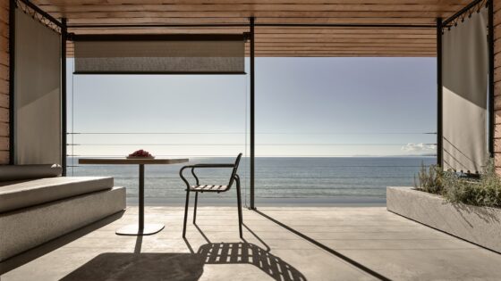 chair and table silhouetted against ocean view in Dexamenes Seaside Hotel