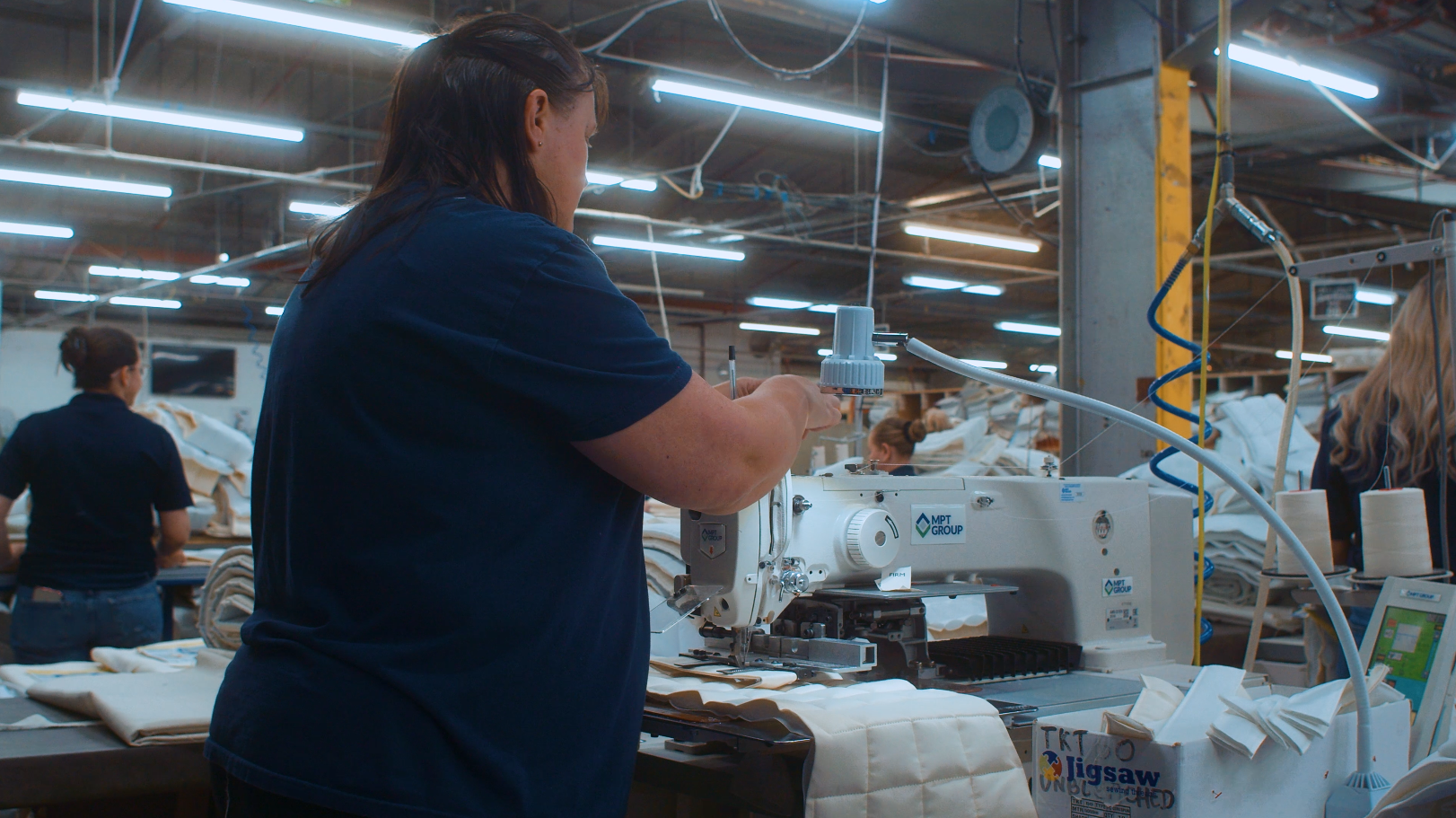Lady sewing mattresses on Hypnos factory floor