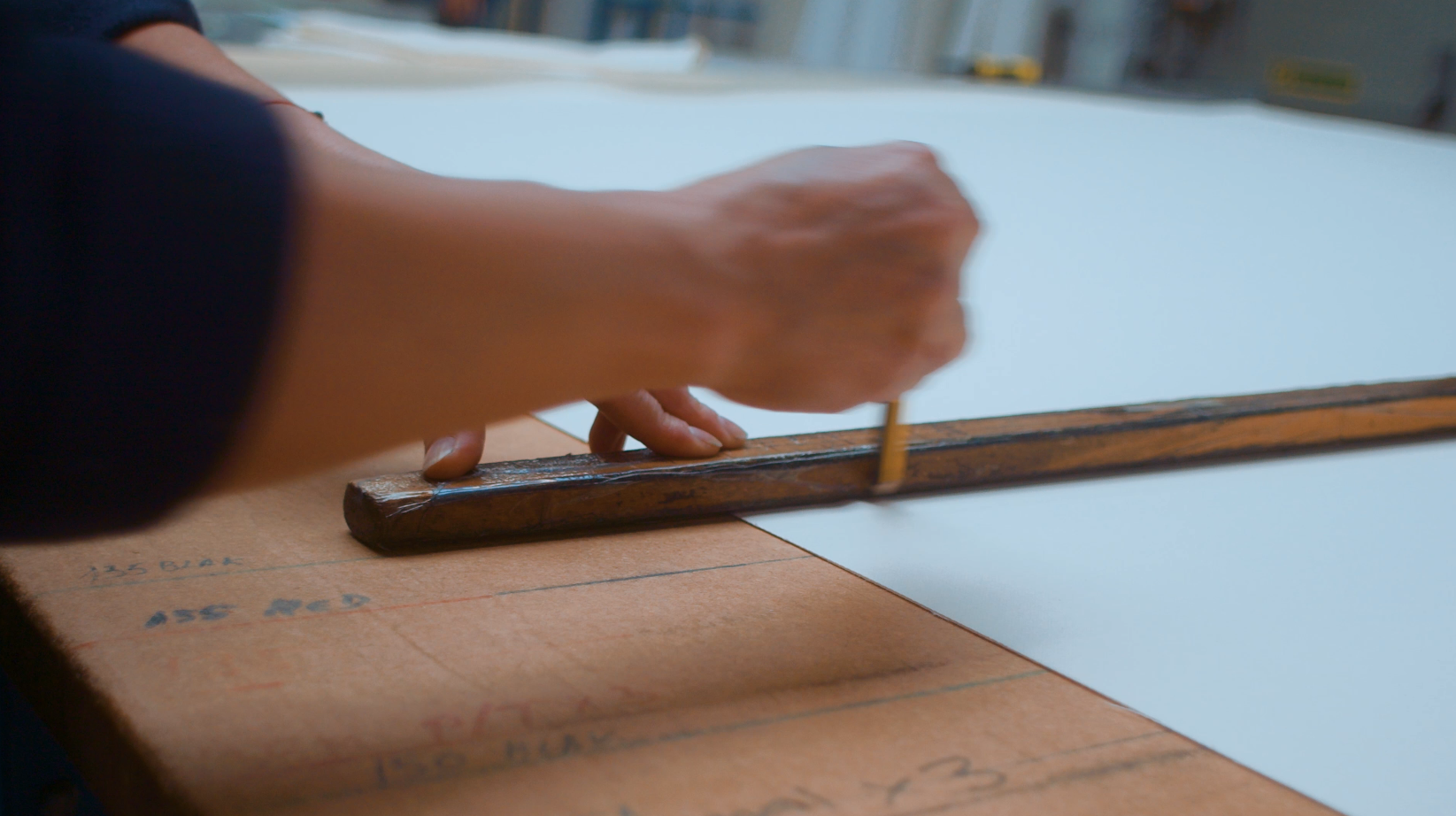 Ruler measuring out material cuttings for mattress