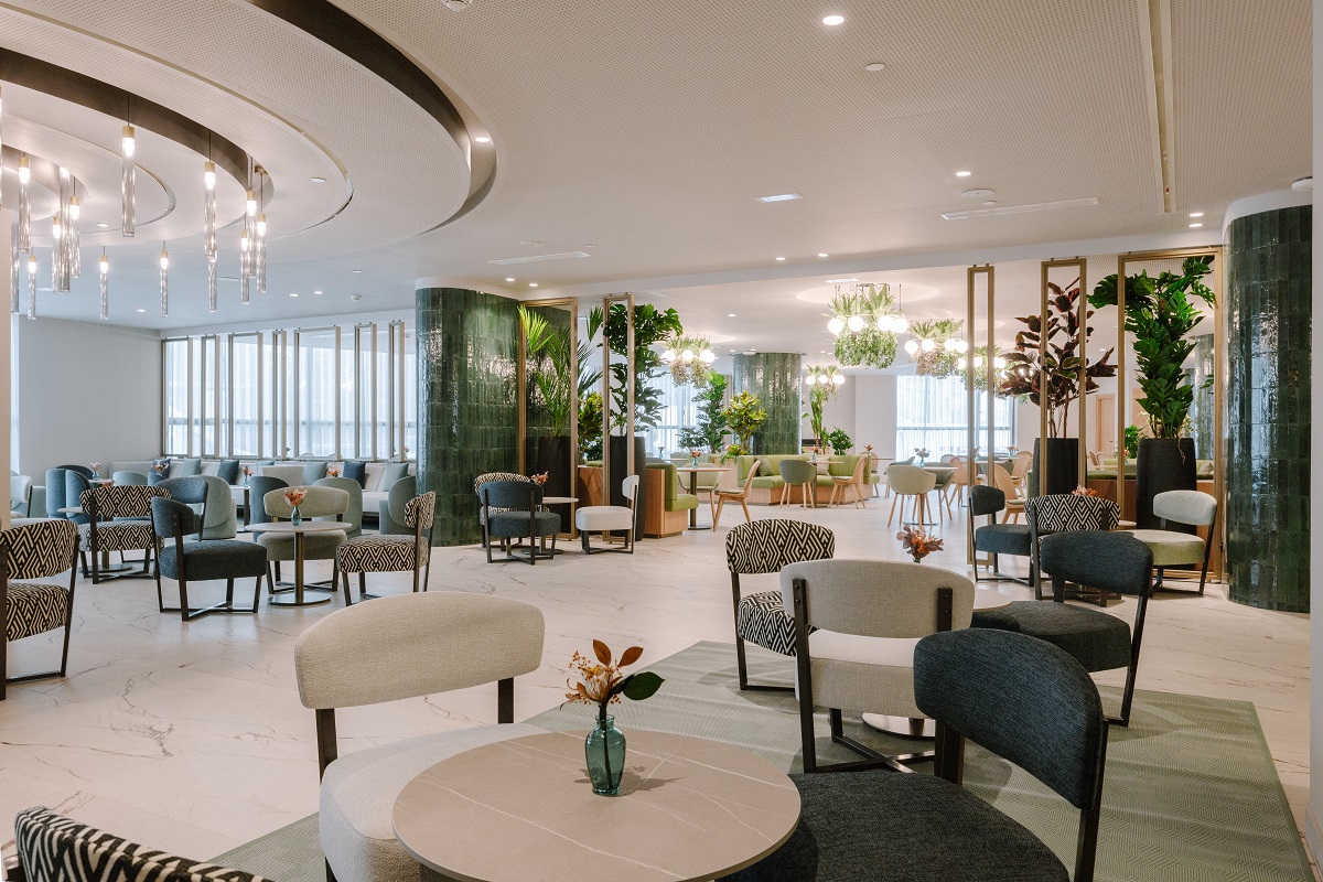 green tiled wall surfaces , plants and cream and green furniture in Royal Hideaway Casablanca