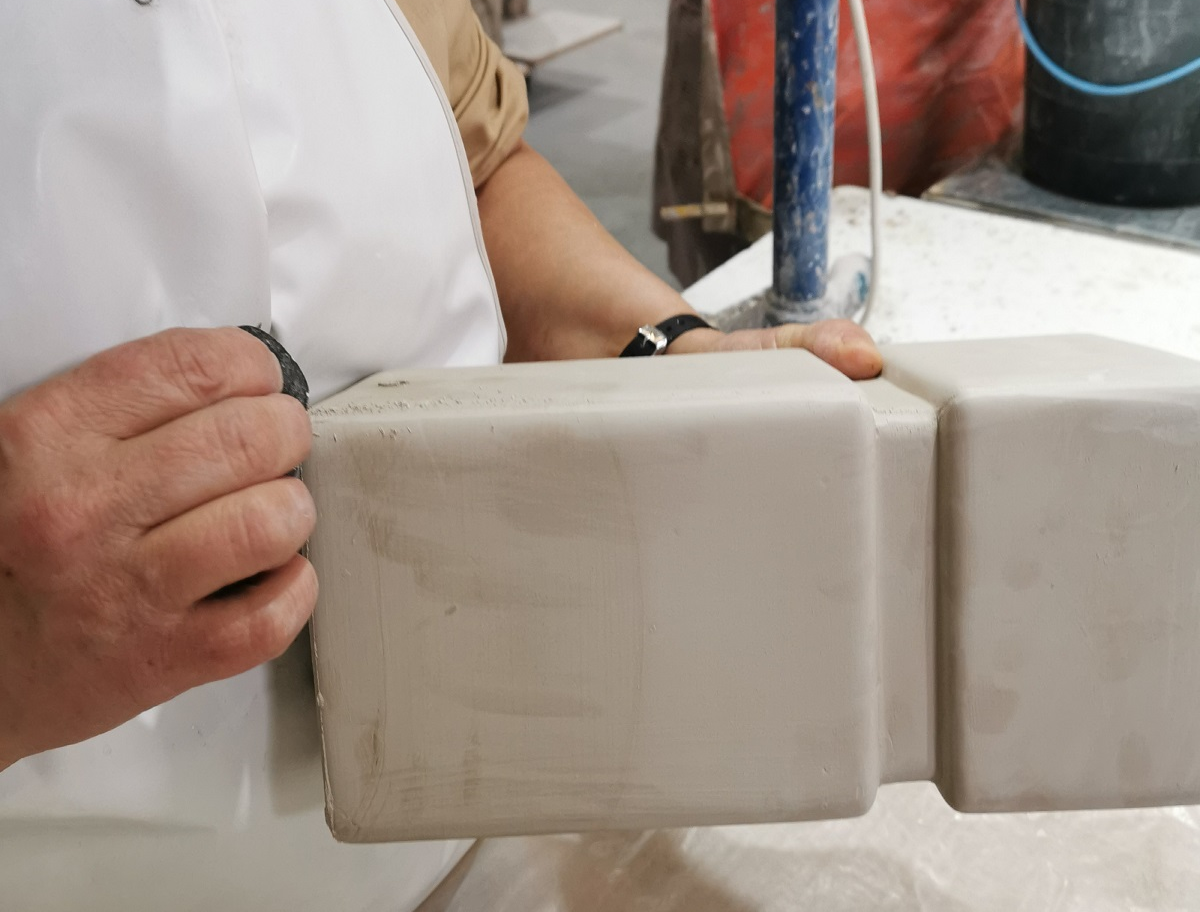 hands and ceramic base - working on the lamp in the Northern Lights factory